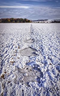 Scenic view of lake against sky during winter