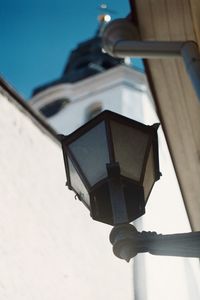 Low angle view of illuminated street light against building