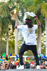 Rear view of singer singing while standing on stage