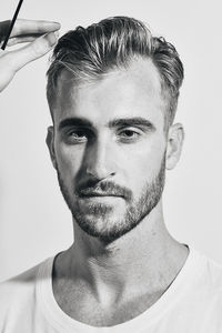 Close-up portrait of young man against white background