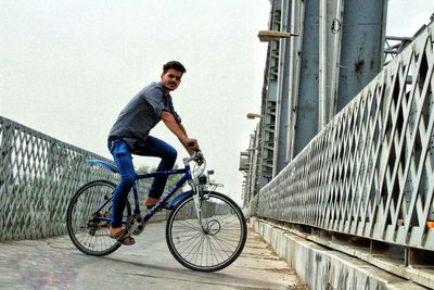 Man riding bicycle on city street