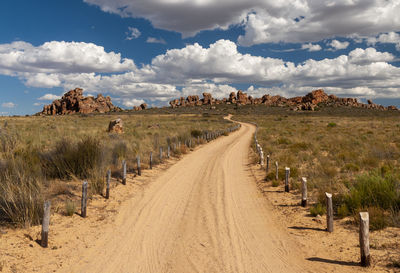 Panoramic shot of dirt road against sky