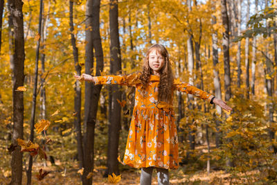 Portrait of woman standing in forest