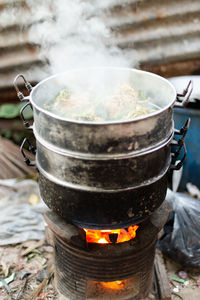 Close-up of tea cup on barbecue grill