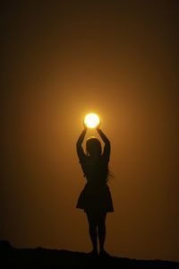 Silhouette man standing against sky during sunset