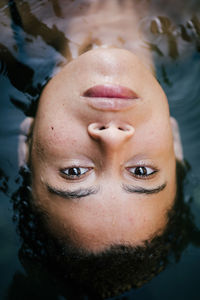 Close-up portrait of young woman in water