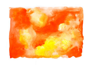 Close-up of orange painted over white background