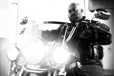 Portrait of young man sitting on motorcycle