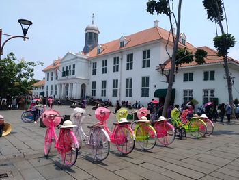 People on street against buildings in city