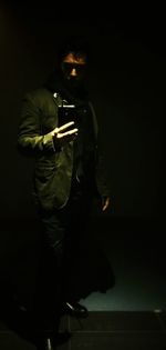 Blurred motion of woman in illuminated room