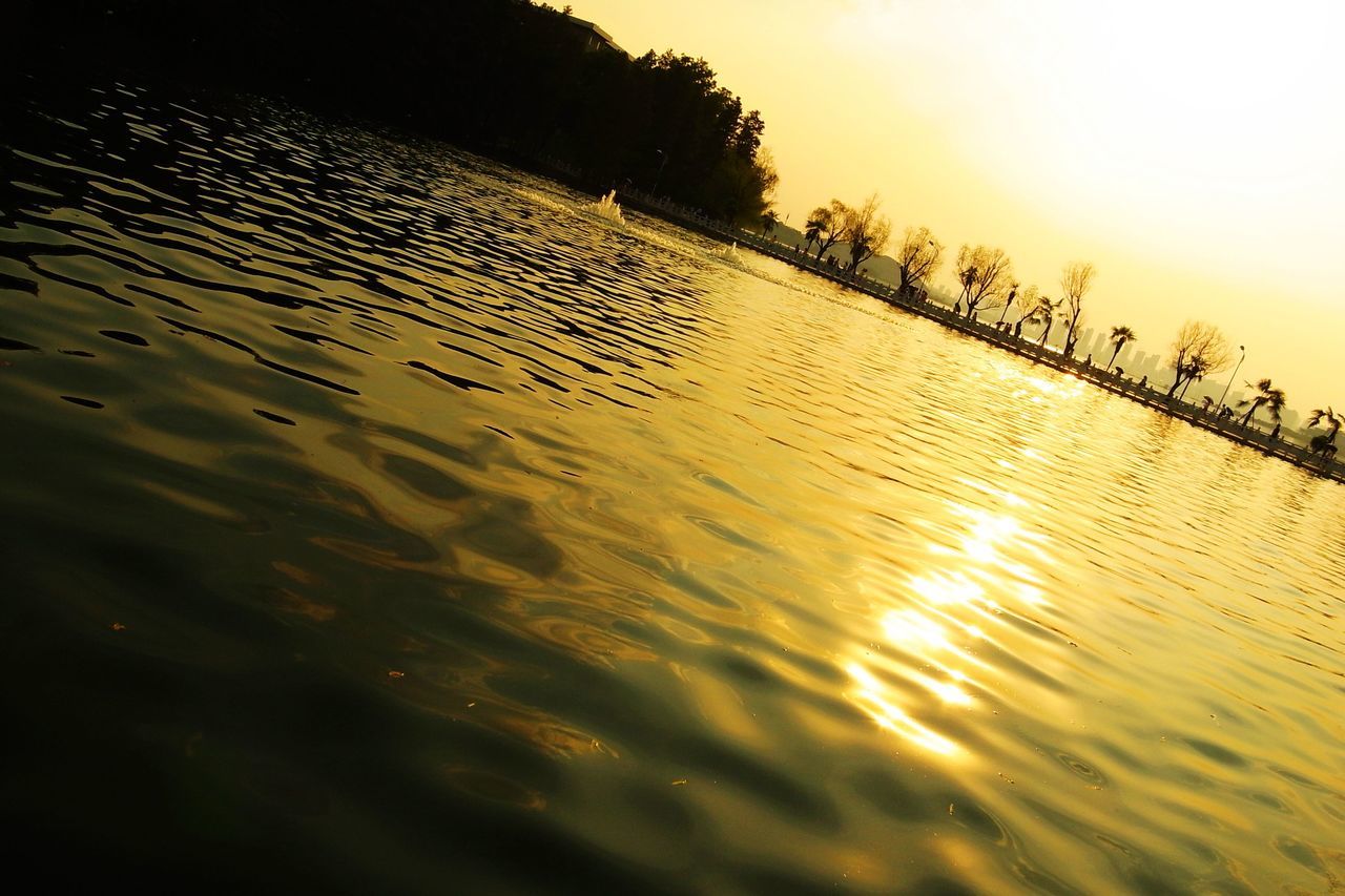 sunset, water, reflection, tranquil scene, tranquility, scenics, waterfront, beauty in nature, sky, nature, idyllic, sun, rippled, silhouette, orange color, sunlight, outdoors, sea, lake, non-urban scene