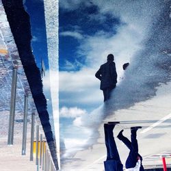 Silhouette of people against cloudy sky