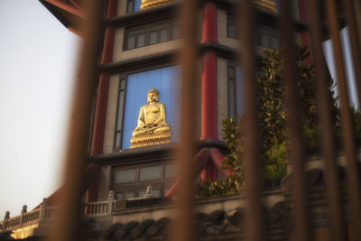 Low angle view of statue against building