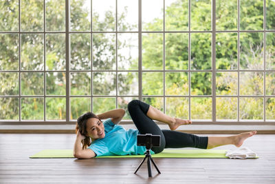 Side view of woman exercising in gym