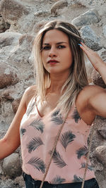 Portrait of young woman standing at beach