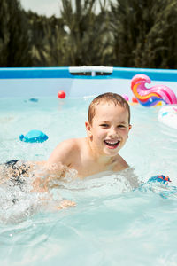 Portrait of boy in wading in pool