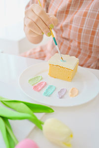 Close-up of woman holding ice cream in plate