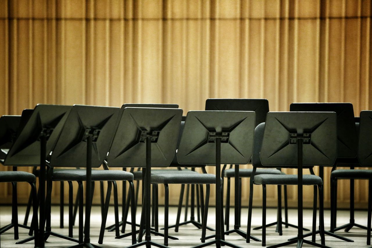 indoors, chair, in a row, side by side, empty, absence, repetition, seat, order, built structure, arrangement, architecture, table, no people, window, restaurant, group of objects, wall - building feature, pattern, day