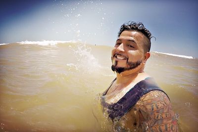 Portrait of a young man swimming in sea