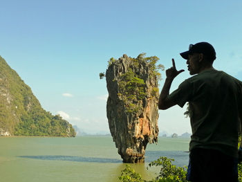 Man standing by sea against clear sky