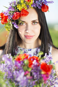 Portrait of smiling woman wearing flowers