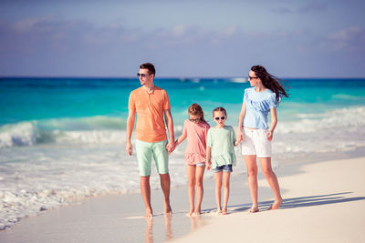 Full length of children on beach against sea