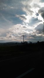 Scenic view of field against cloudy sky