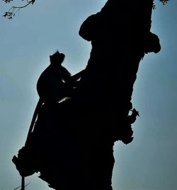 Low angle view of silhouette people against sky