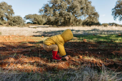 Cute boy playing on soil