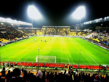 Group of people in soccer field at night