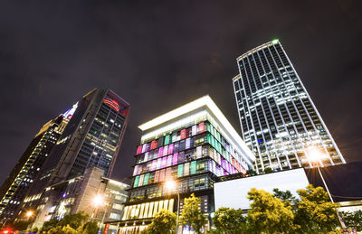 Low angle view of modern commercial buildings at night in taipei, taiwan.