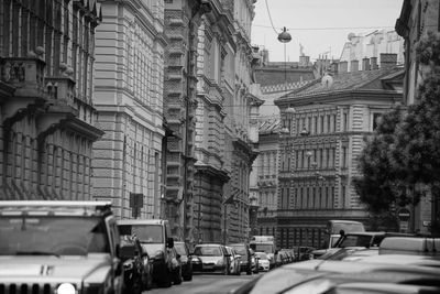 Traffic on road amidst buildings in city