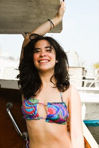 Portrait of smiling young woman sitting in gym