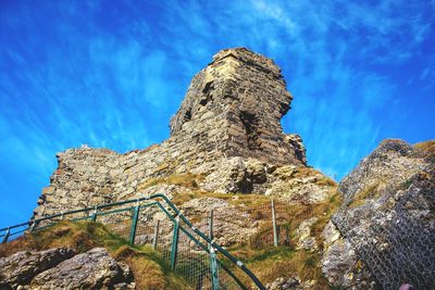 Low angle view of rock formation against sky
