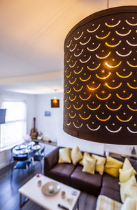 Close-up of illuminated pendant lights on table at home