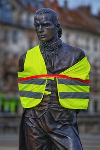 Close-up of statue against building in city