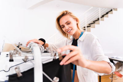 Young fashion designer working at boutique