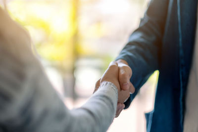 Close-up of business people doing handshake