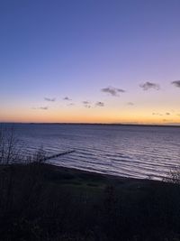 Scenic view of sea against sky at sunset