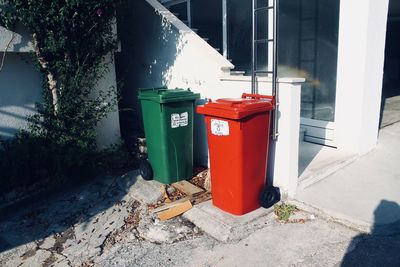 Garbage bin by building in city