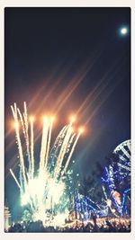 Low angle view of illuminated ferris wheel