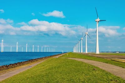 Windmill on field against sky,