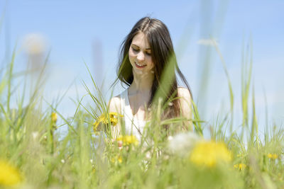 Portrait of woman standing on field