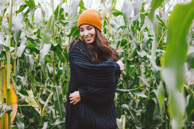 Portrait of a smiling young woman standing in field