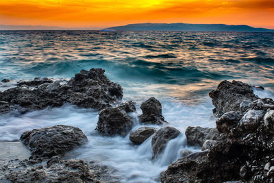 Scenic view of sea against sky during sunset