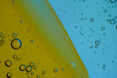 Top view oil bubbles drop on the water with colorful background, macro photography concept