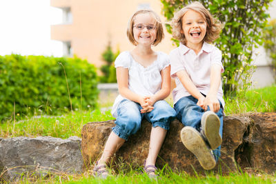 Portrait of smiling girl sitting outdoors