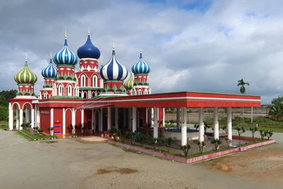 View of red building against cloudy sky