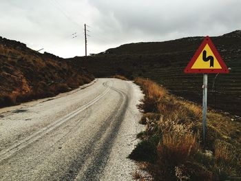 Empty road along countryside landscape