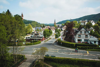 High angle view of street by buildings against sky